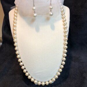 Elegant and classic faux pearl necklace strand with dangling earrings to match.